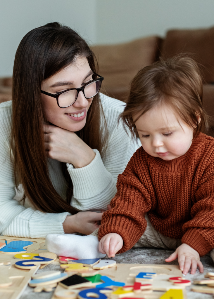 Nanny with Baby doing puzzle